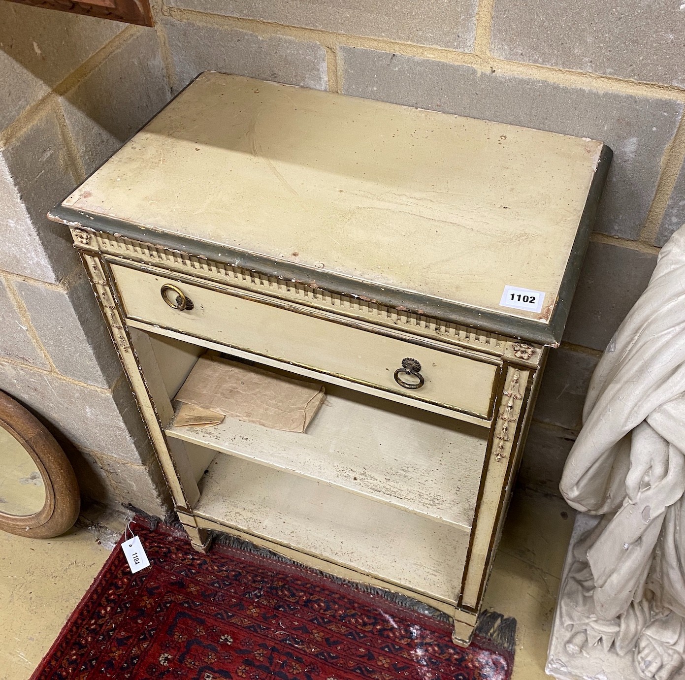 An Adam style cream painted and gilt open bookcase, width 60cm, height 84cm